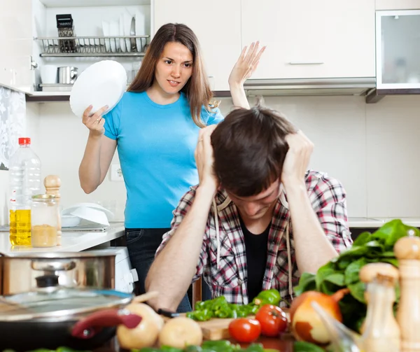 Sad man with angry wife at kitchen — Stock Photo, Image