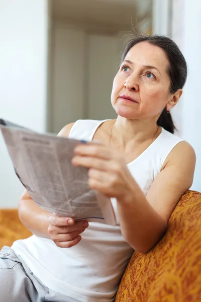Wistful  woman with newspaper — Stock Photo, Image