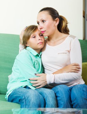 Mother comforting boy clipart