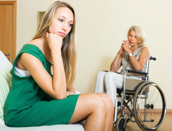 Tired woman and disabled person — Stock Photo, Image