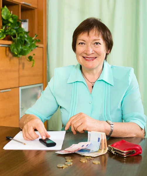 Portrait of positive female pensioner with cash and bills — Stock Photo, Image