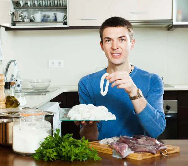 Happy man with raw squid — Stock Photo, Image