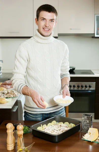 Guy cooking meat with cheese — Stock Photo, Image