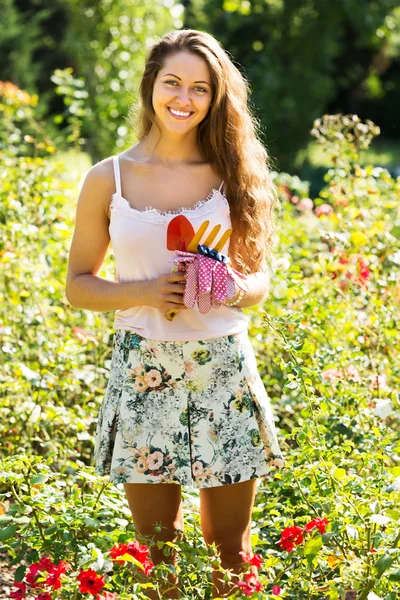 Female florist in summer garden — Stock Photo, Image