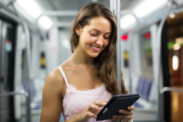 电子书阅读器在地铁列车中的女人 — 图库照片