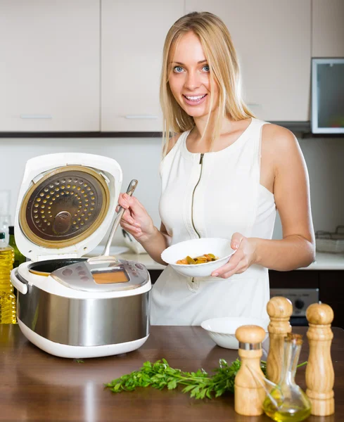 Woman cooking with multicooker — Stock Photo, Image