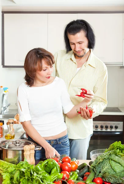Woman and man  adding spices to the pot — Stock Photo, Image