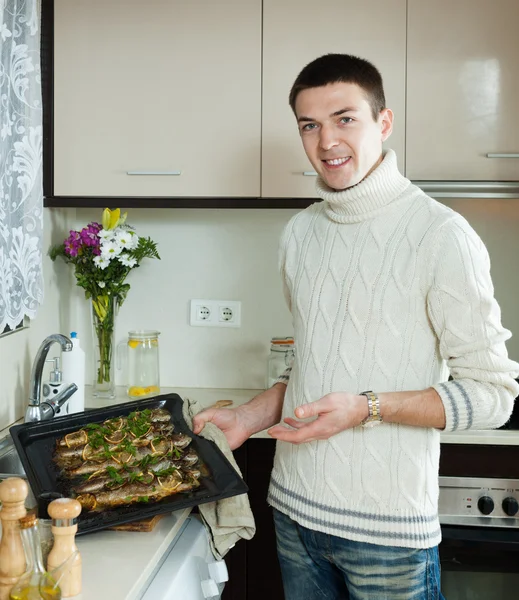 Man with cooked fish on  frying pan — Stock Photo, Image