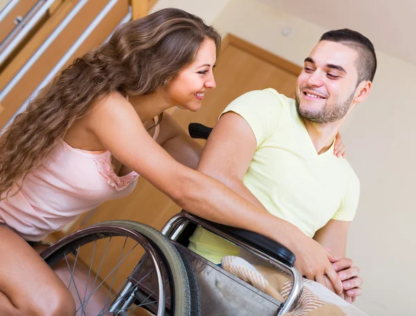 Girl  with  boyfriend in wheelchair — Stock Photo, Image