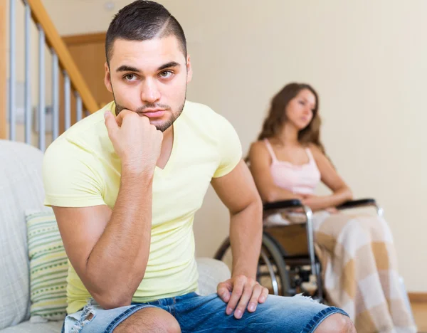 Man with girlfriend in invalid chair — Stock Photo, Image