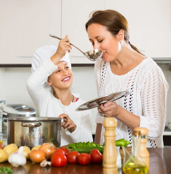 Anne ve kızı birlikte yemek pişiriyor. — Stok fotoğraf