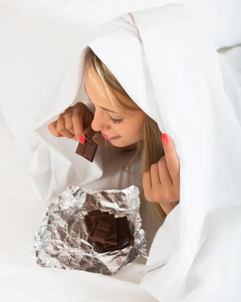 Girl eating chocolate — Stock Photo, Image