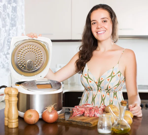 Woman with multi cooker — Stockfoto