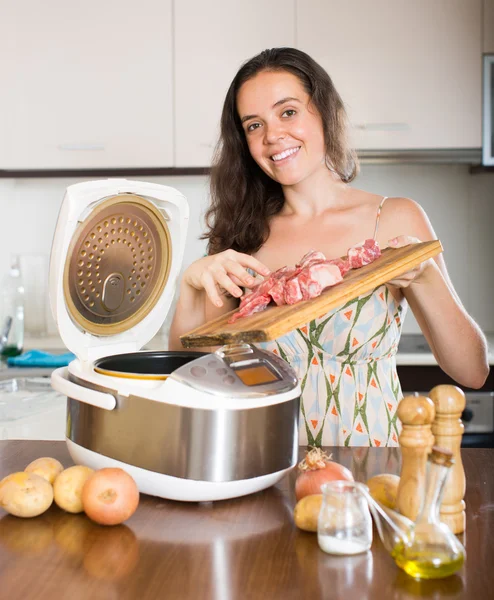 Woman with multi cooker — Stockfoto
