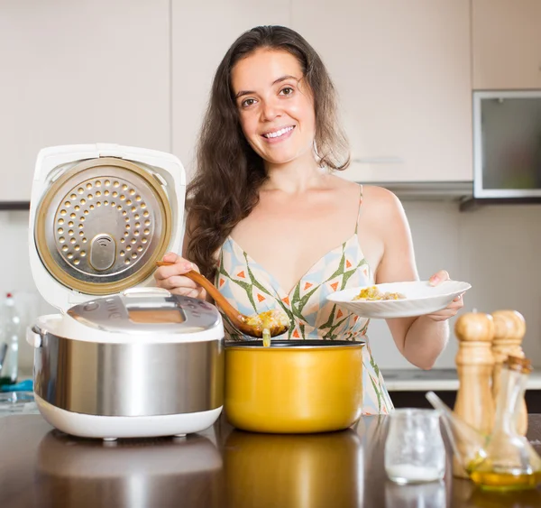 Woman with multi cooker — Stockfoto