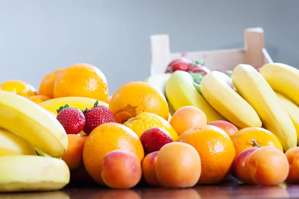Various fresh fruits at table — Stock Photo, Image