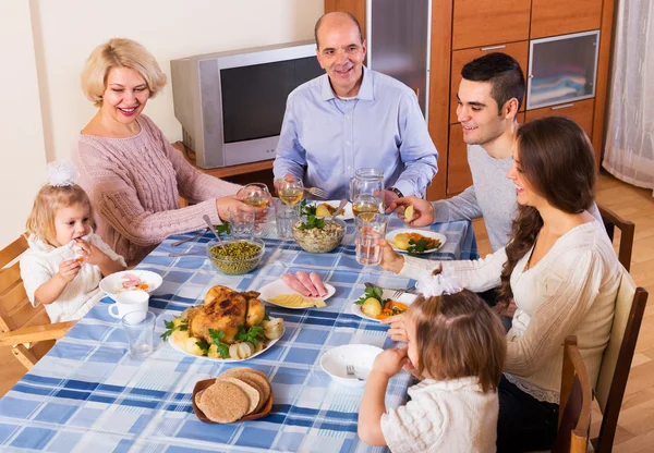 Family sitting at table — Stock Photo, Image