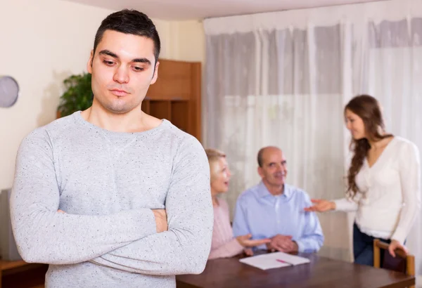 Upset man against united family — Stock Photo, Image