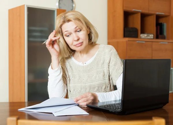 Mature woman staring financial documents — Stock Photo, Image