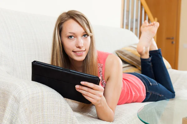 Menina no sofá com tablet pc — Fotografia de Stock