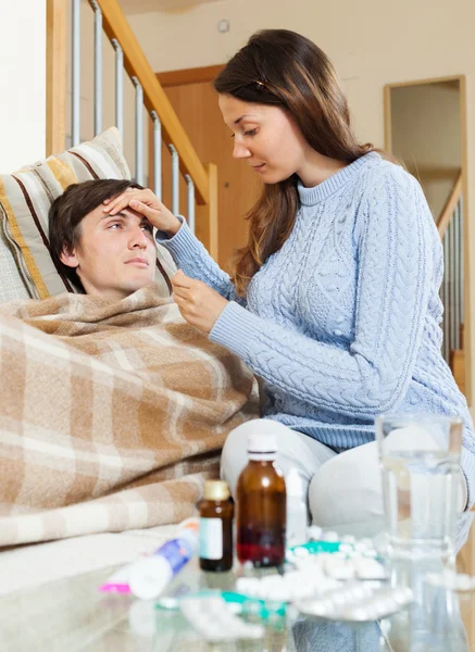 Woman caring for sick guy — Stock Photo, Image