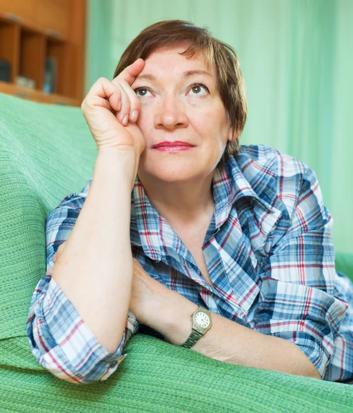 Stressed female pensioner on couch — Stock Photo, Image