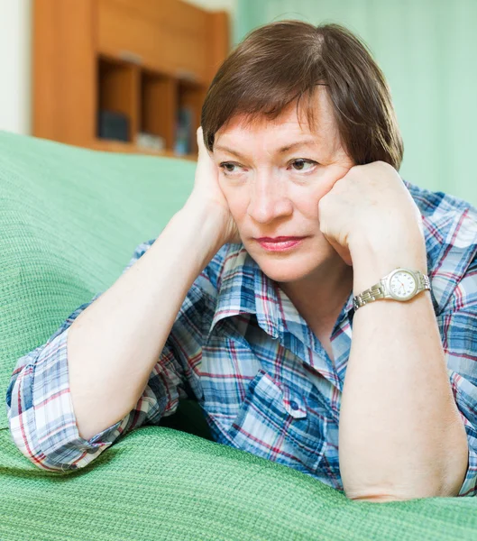 Stressed female pensioner on couch — Stock Photo, Image