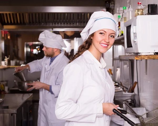 Chef and his helper at kitchen — Stock Photo, Image