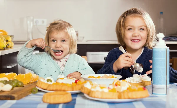 Two little girls with cream desserts — Stock Photo, Image