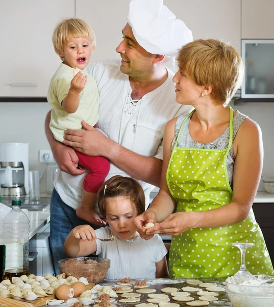 Happy family making dumplings — Stock Photo, Image