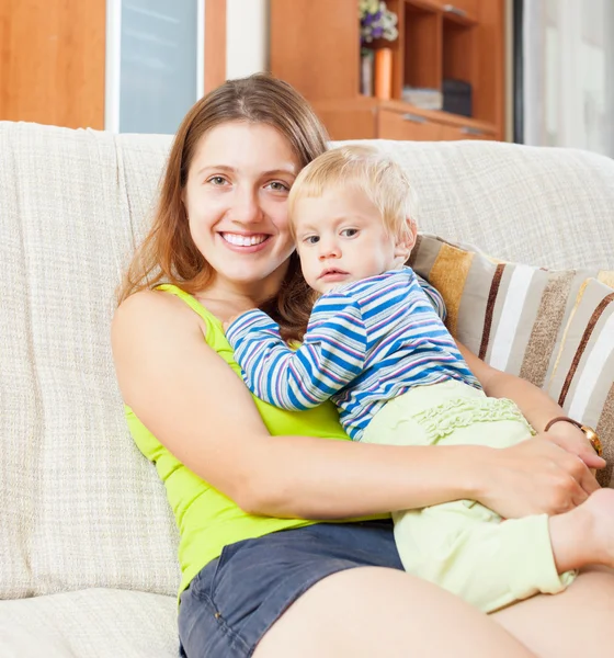 Smiling long-haired woman with toddler — Stock Photo, Image