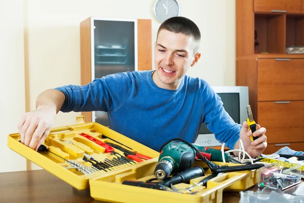 Smiling man organizing tools in toolbox Royalty Free Stock Photos