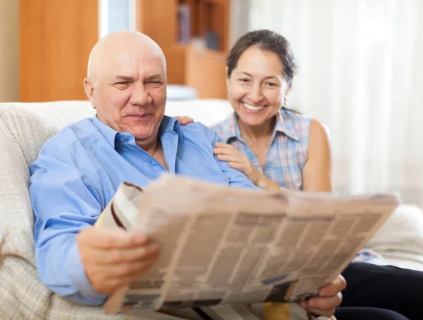 Vrouw en ouderen man met krant — Stockfoto