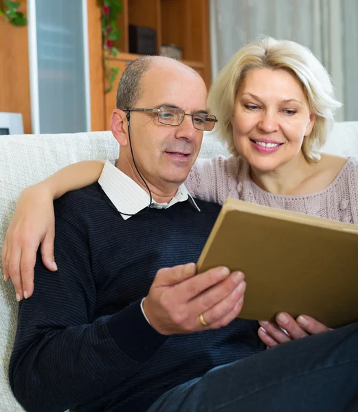 Gelukkig gepensioneerden kijken naar oude foto 's — Stockfoto