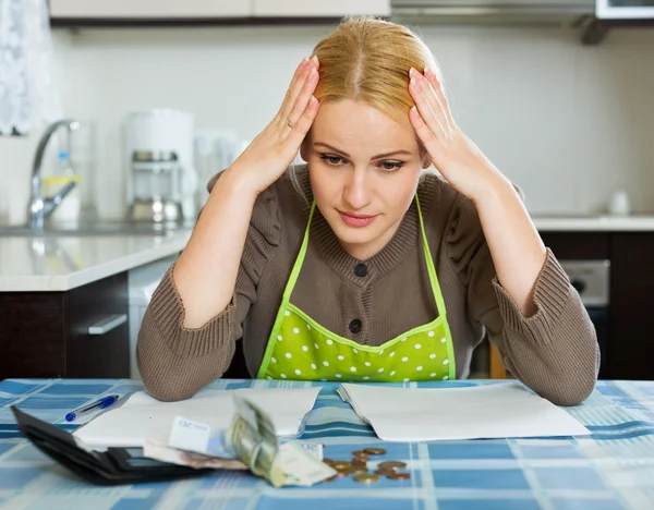 Sad woman calculating family budget — Stock Photo, Image