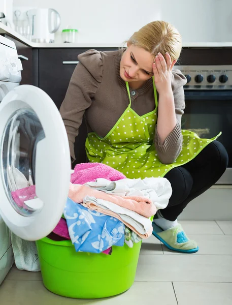 Tired woman doing laundry — Stock Photo, Image