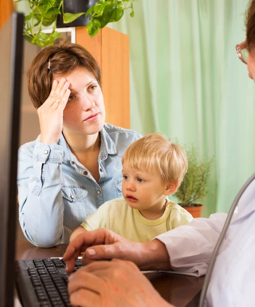 Mulher com bebê médico ouvindo — Fotografia de Stock