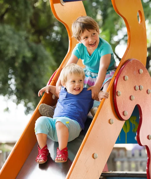 Happy children on slide — Stock Photo, Image