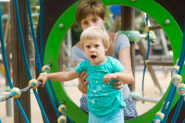 Girl with mother at action-oriented playground — Stock Photo, Image