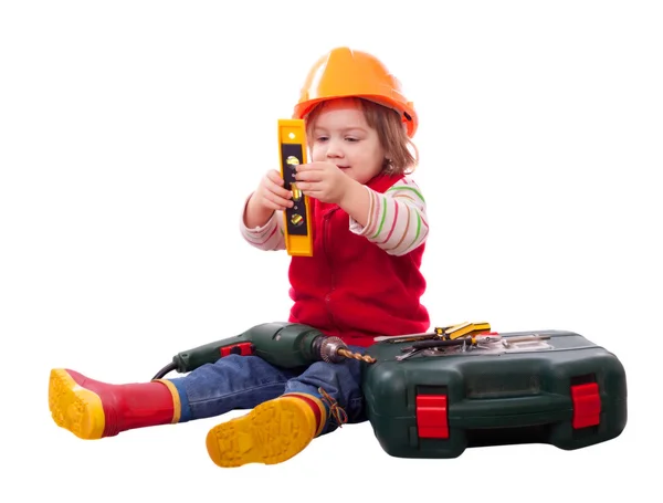 Child in builder hardhat with tools — Stock Photo, Image