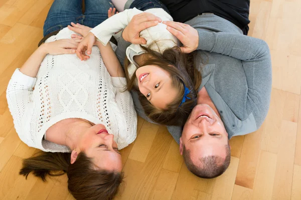 Family smiling at floor — Stock Photo, Image