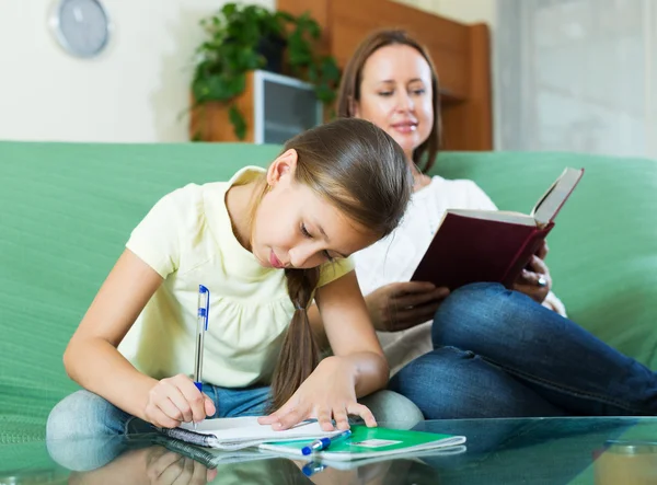 Mother with little daughter  doing homework Stock Picture