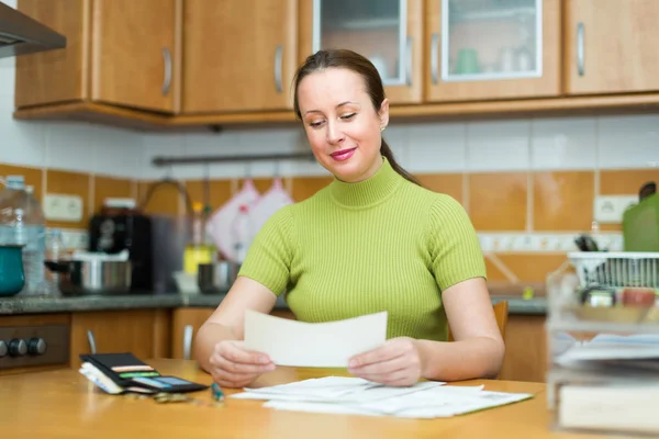 Woman at table with documents — Stock Photo, Image