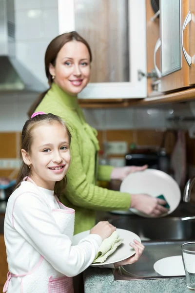 Ragazza con madre lavare i piatti — Foto Stock