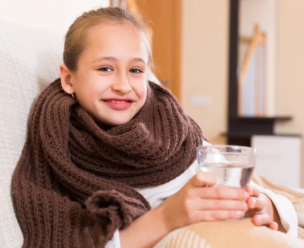 Meisje in warme sjaal drinken uit glas — Stockfoto