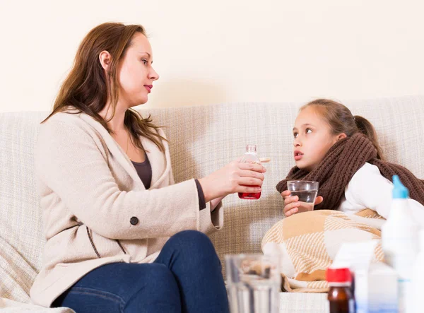 Woman caring for sick daughter — Stock Photo, Image