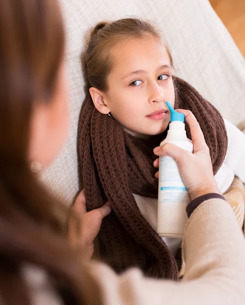 Woman treating daughter for rhinitis — Stock Photo, Image
