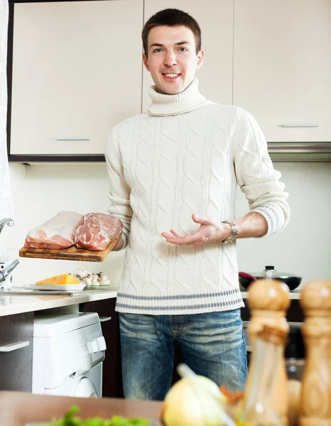 Hombre ordinario sosteniendo carne cruda — Foto de Stock