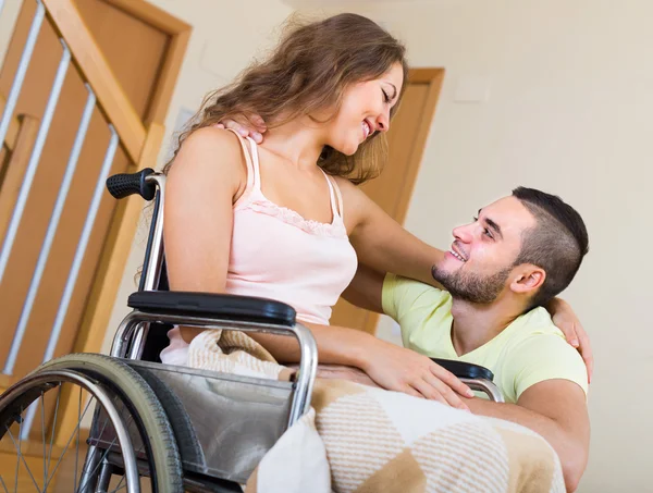 Loving girl in wheelchair with her boyfriend — Stock Photo, Image