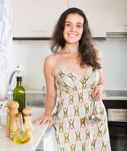 Jovem mulher sorridente na cozinha — Fotografia de Stock